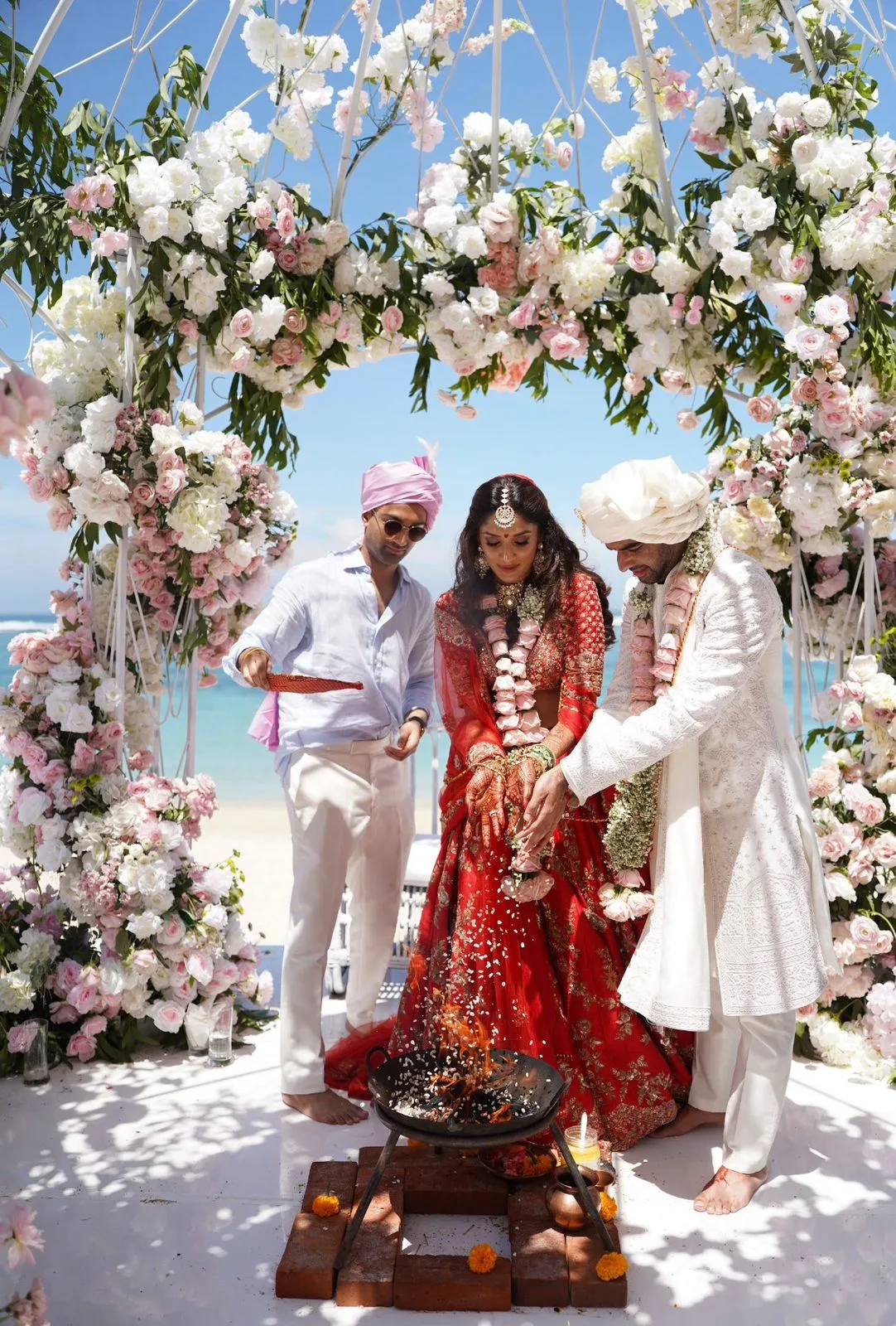 Jai and Kajul before the sacred fire during their seaside wedding ceremony