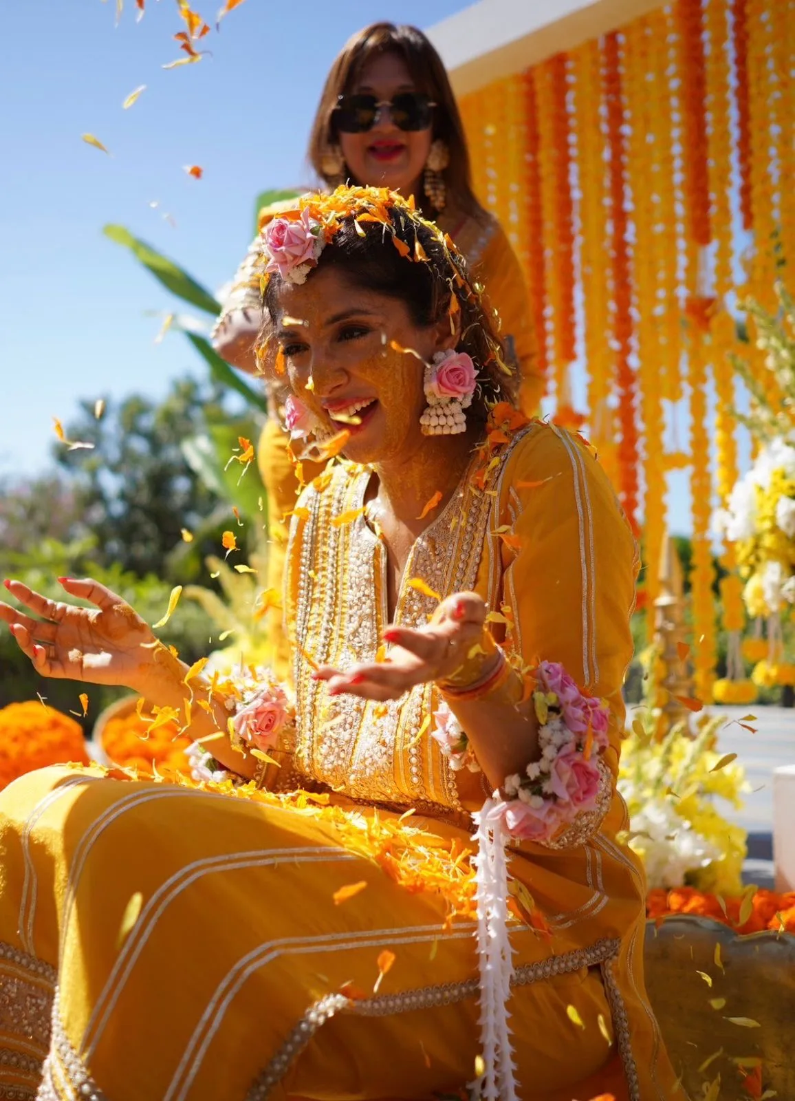 Marigold petals falling during a haldi ceremony