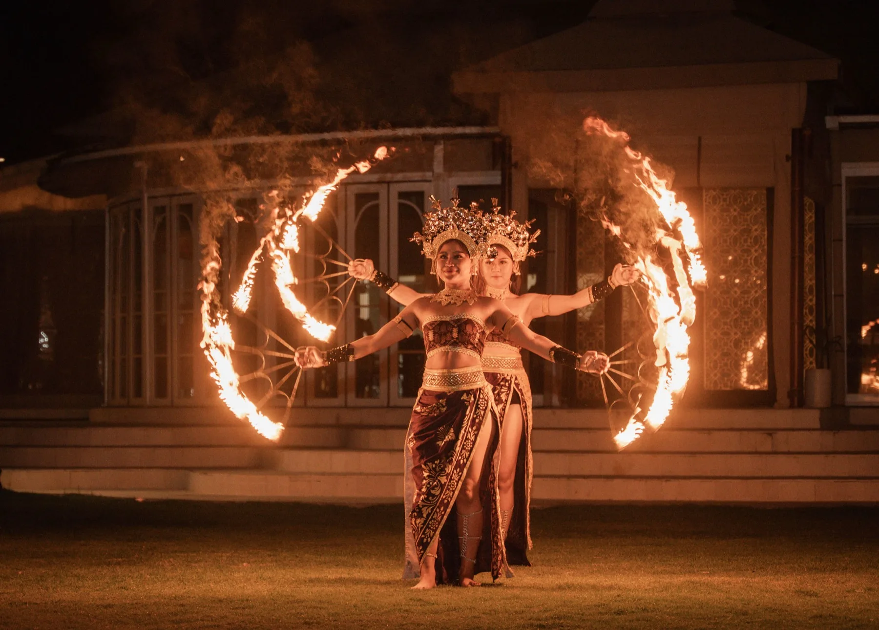 Twin fire dancers in traditional Balinese headdress perform for Kersten and William
