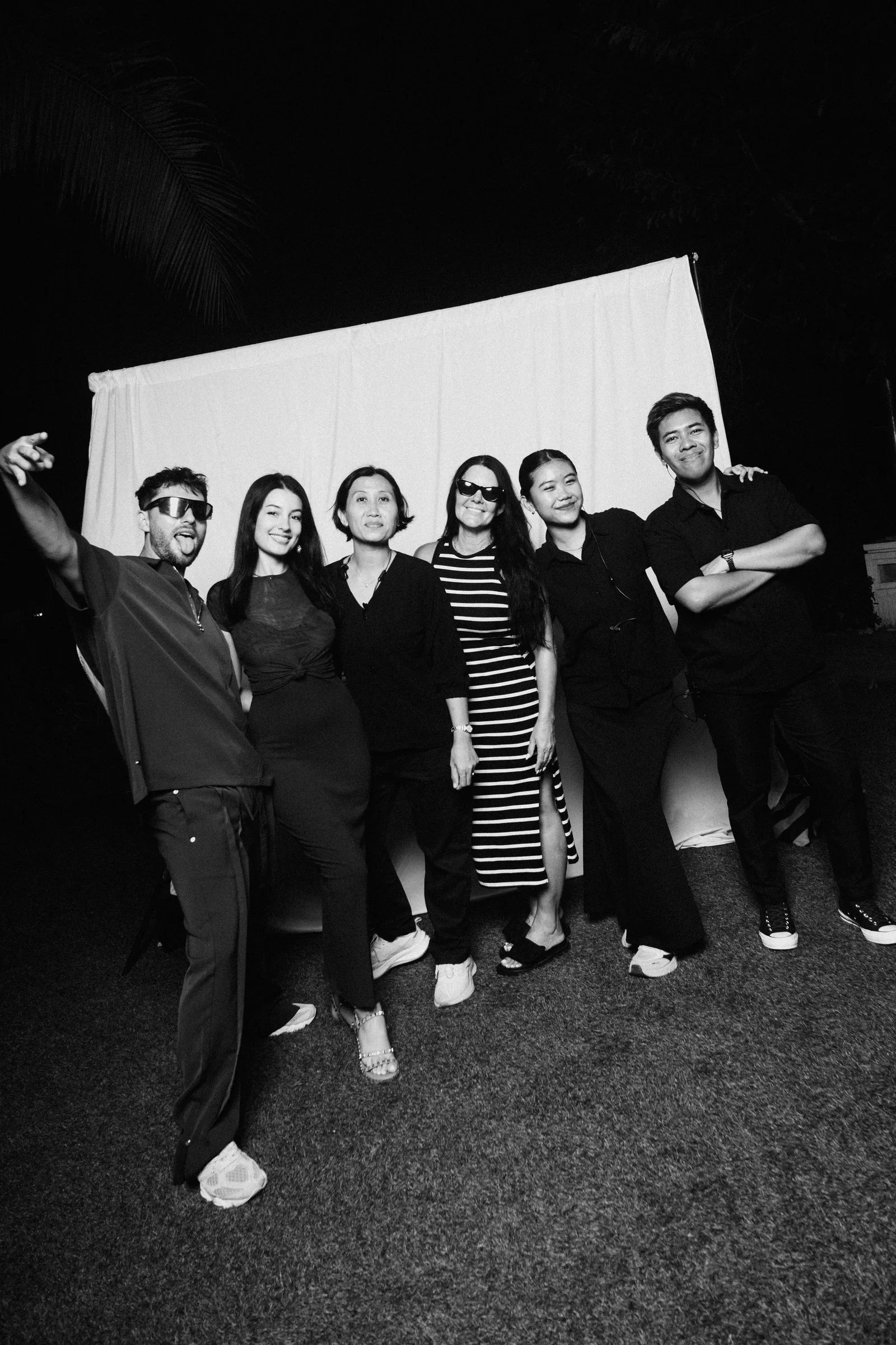 The ICE team together at night, in front of a white backdrop